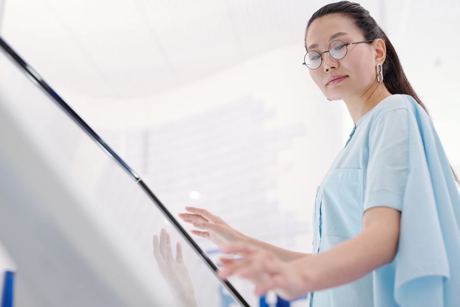 When to Buy Life Insurance: Best Age and Life Stage Explained Stylish woman using a touchscreen display indoors emphasizing modernity and fashion.