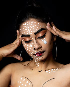 A woman with creative pop art makeup poses against a black background, showcasing artistic style.