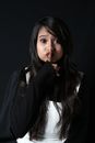 Young woman showing keep silence gesture