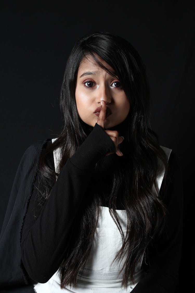 Young Woman Showing Keep Silence Gesture