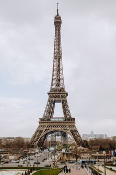 Iconic view of the Eiffel Tower in Paris, France captured on a cloudy day, showcasing its architectural beauty.