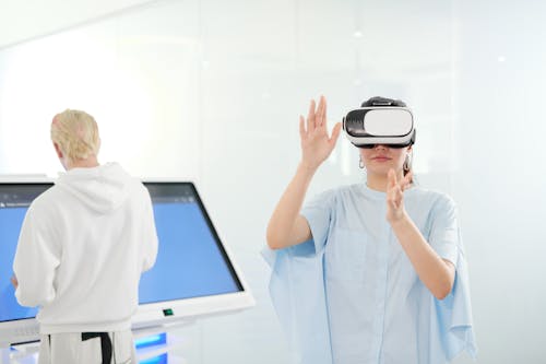 Woman in Blue Shirt with VR Goggles on Head