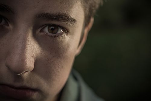 Free Close-up of a young adult with a thoughtful expression, showcasing emotions. Stock Photo