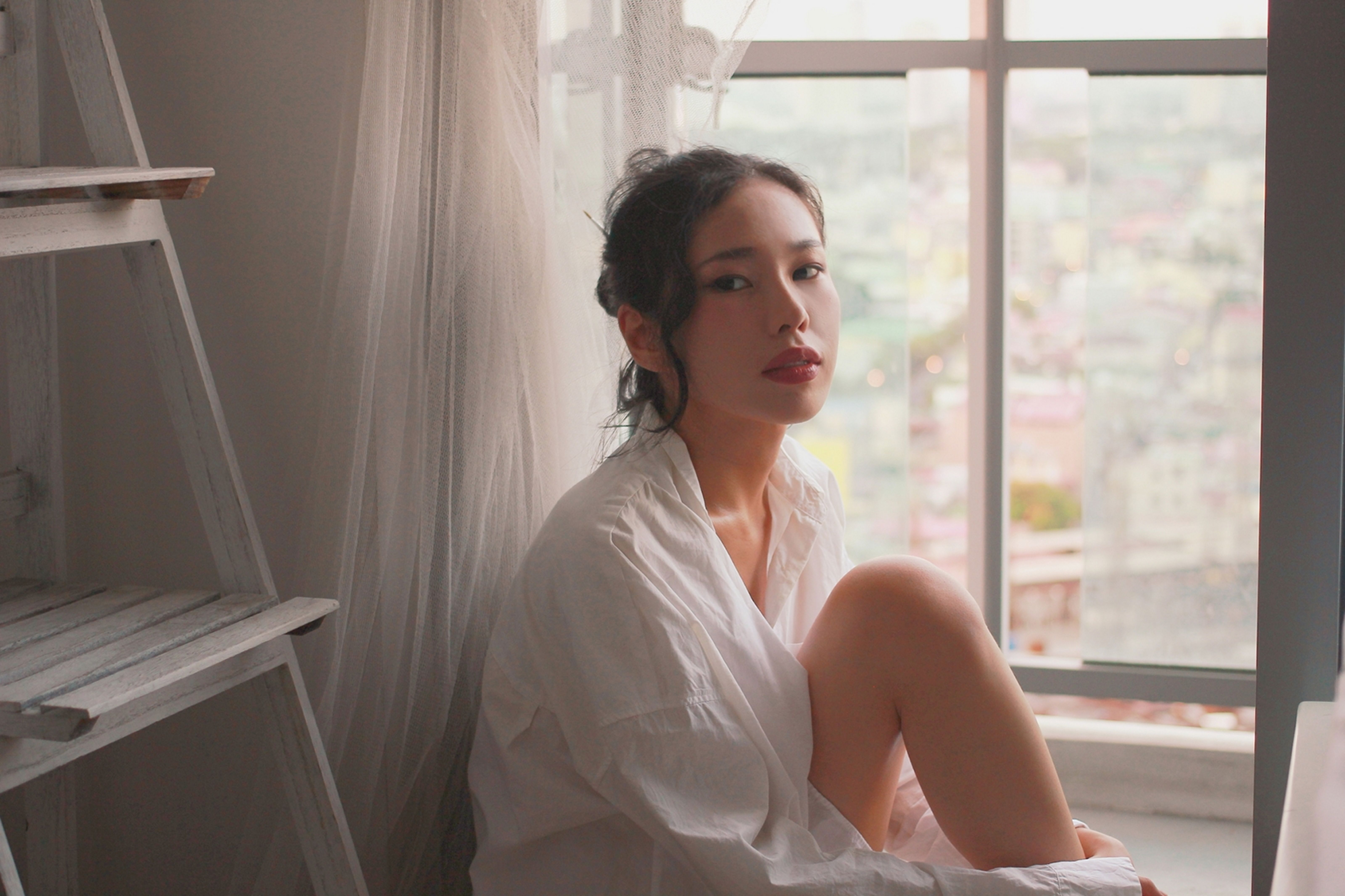 Sand-toned cotton button down shirt at quiet Gangnam cafe window in afternoon light