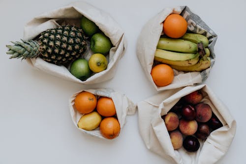 Free Various Fruit in Sacks Against White Background Stock Photo