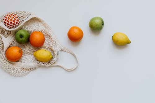 Orange and Lemon Fruits Inside the White Net Bag 