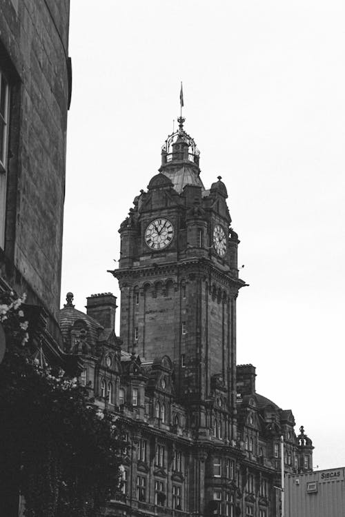 Black and white of majestic clock tower of Balmoral Hotel in Edinburg in UK