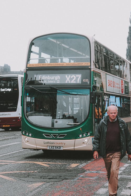 Tourist in front of double decker bus