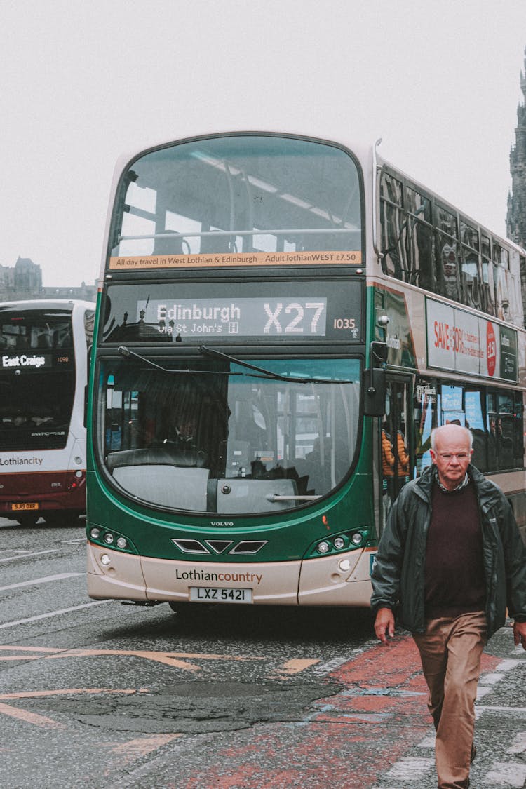 Tourist In Front Of Double Decker Bus