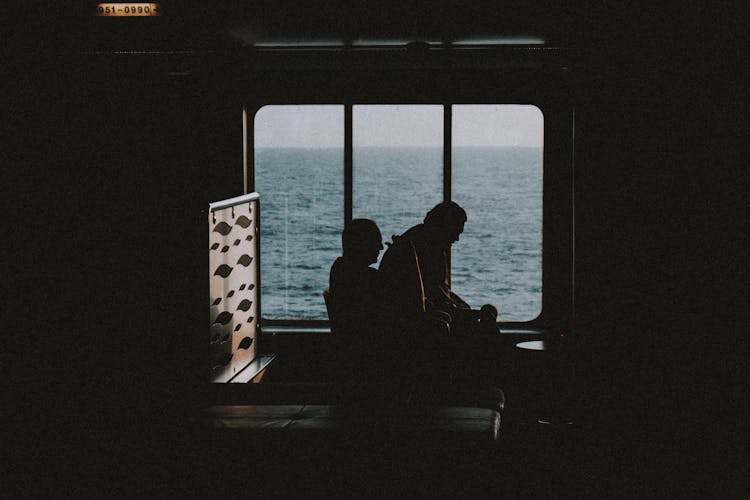 Unrecognizable People Resting In Dark Room On Cruise Ship