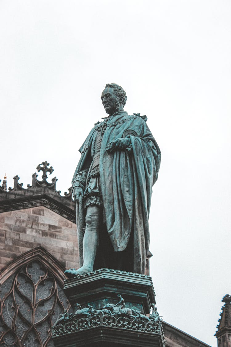 Statue Of Adult Man In Cloak