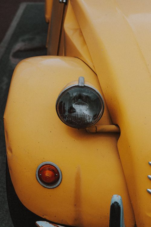 Free Big round transparent headlight and red turn signal on fender of colorful retro automobile Stock Photo