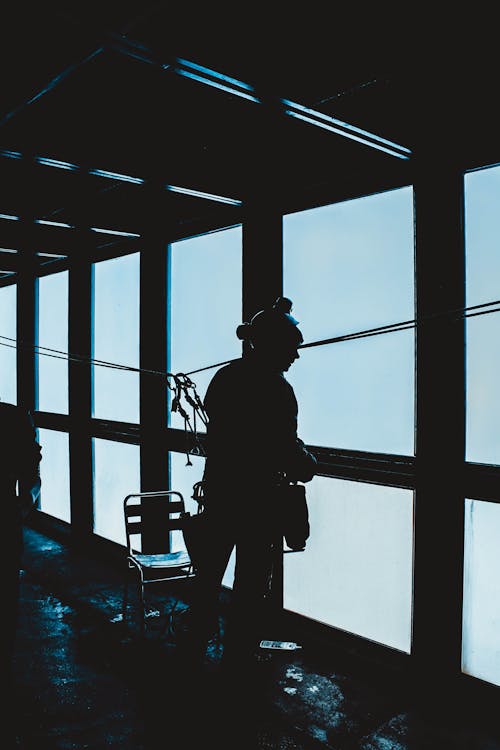 Free Silhouette of mountain climber in observation room Stock Photo