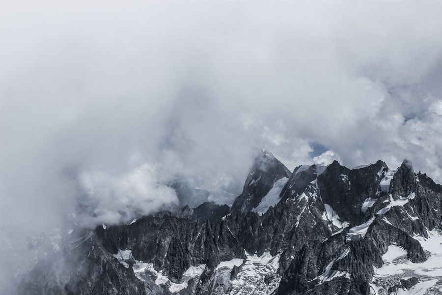 Cloud breaking over a snow ridge, photo by Mathias Reding on Pexels