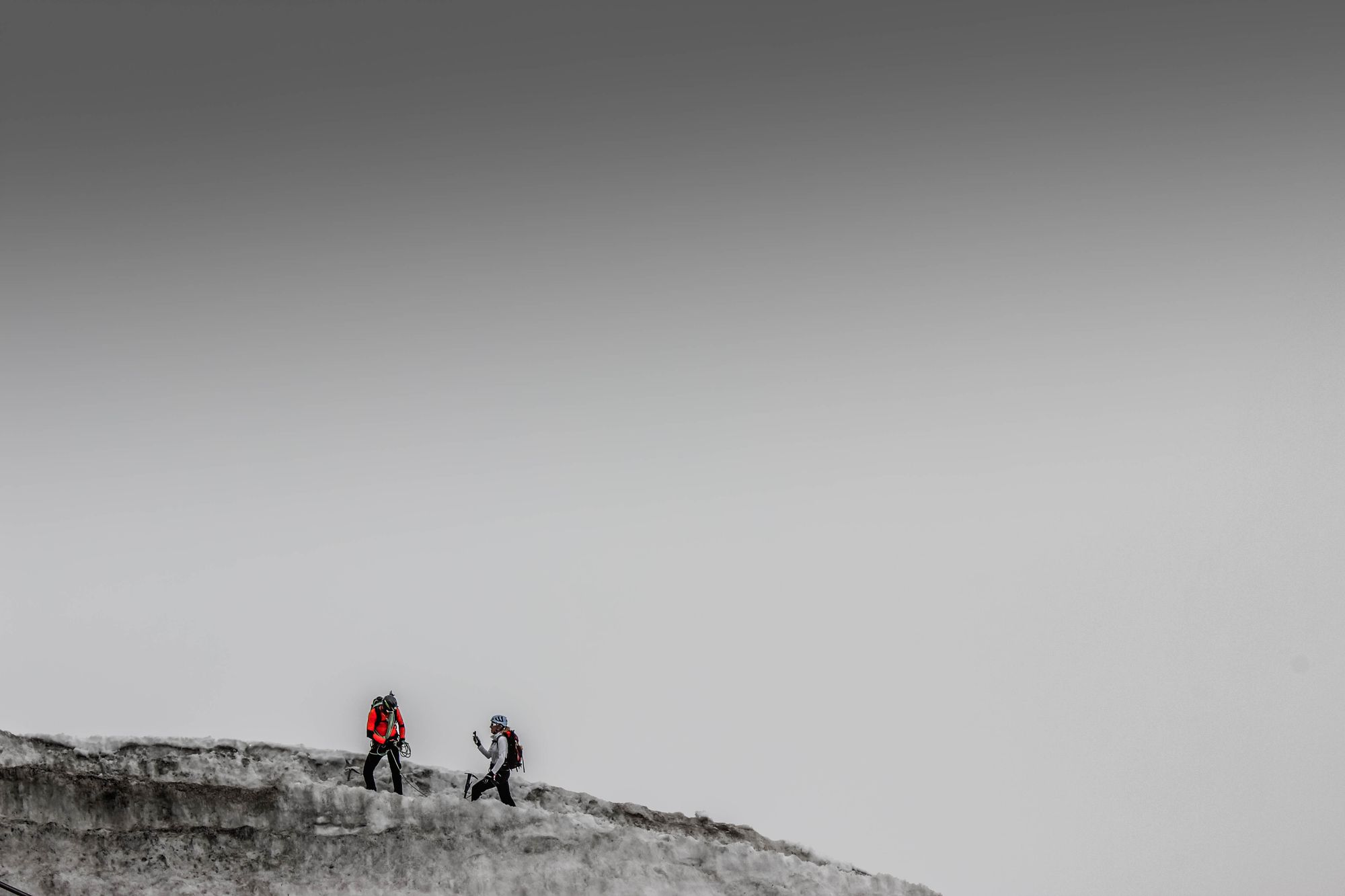 Mountaineers climbing a rocky snowy range