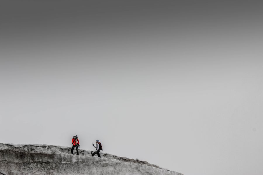 Mountaineers climbing a rocky snowy range