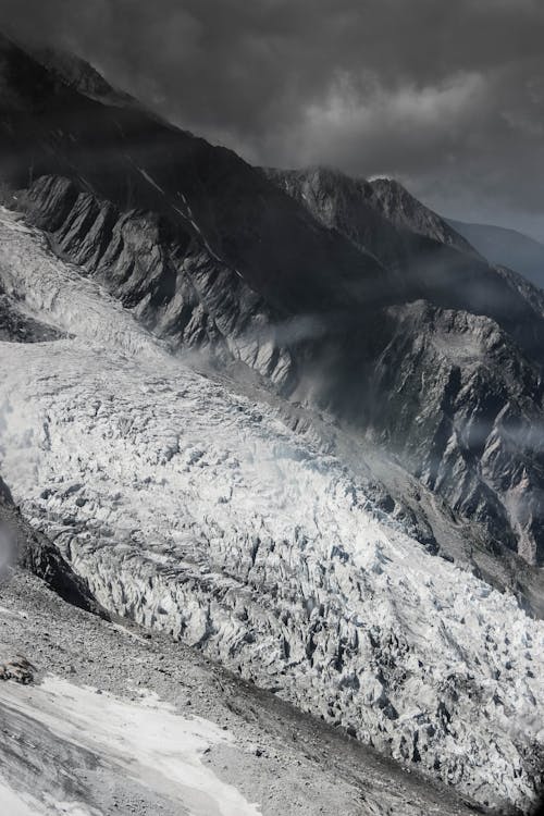 Rough frozen mountains under gloomy sky