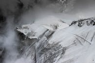 Stiff mountain slop under snow and fog