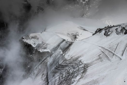 Stiff mountain slop under snow and fog