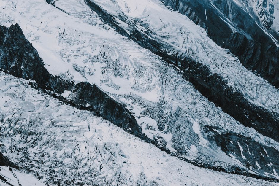 From above dramatic massive mountain slope covered with snow and ice on high altitude