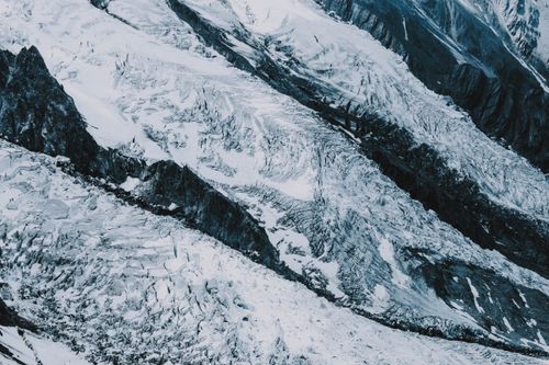 Free From above dramatic massive mountain slope covered with snow and ice on high altitude Stock Photo