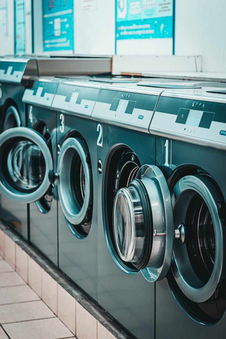 Row Of Modern Washing Machines In Laundry