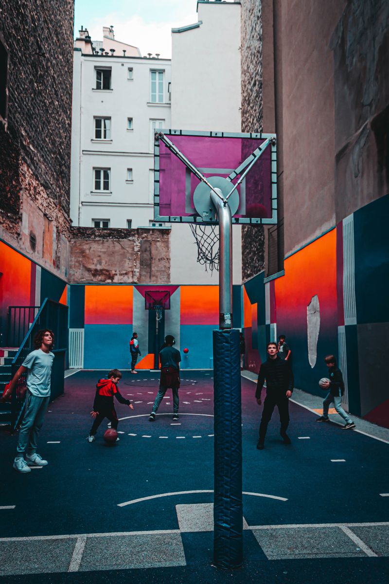 Teenagers playing a pickup game on an outdoor court