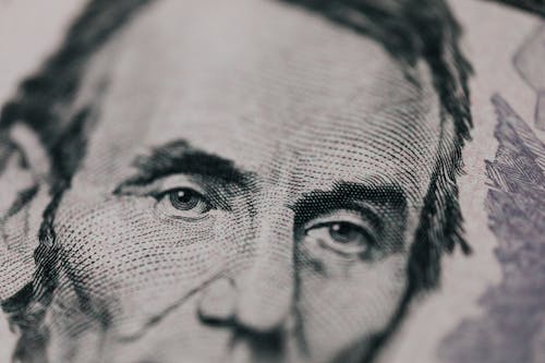 Free Closeup of male American president printed on five dollar bill and looking away pensively Stock Photo