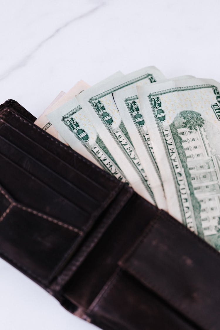 Black Wallet With Dollar Banknotes