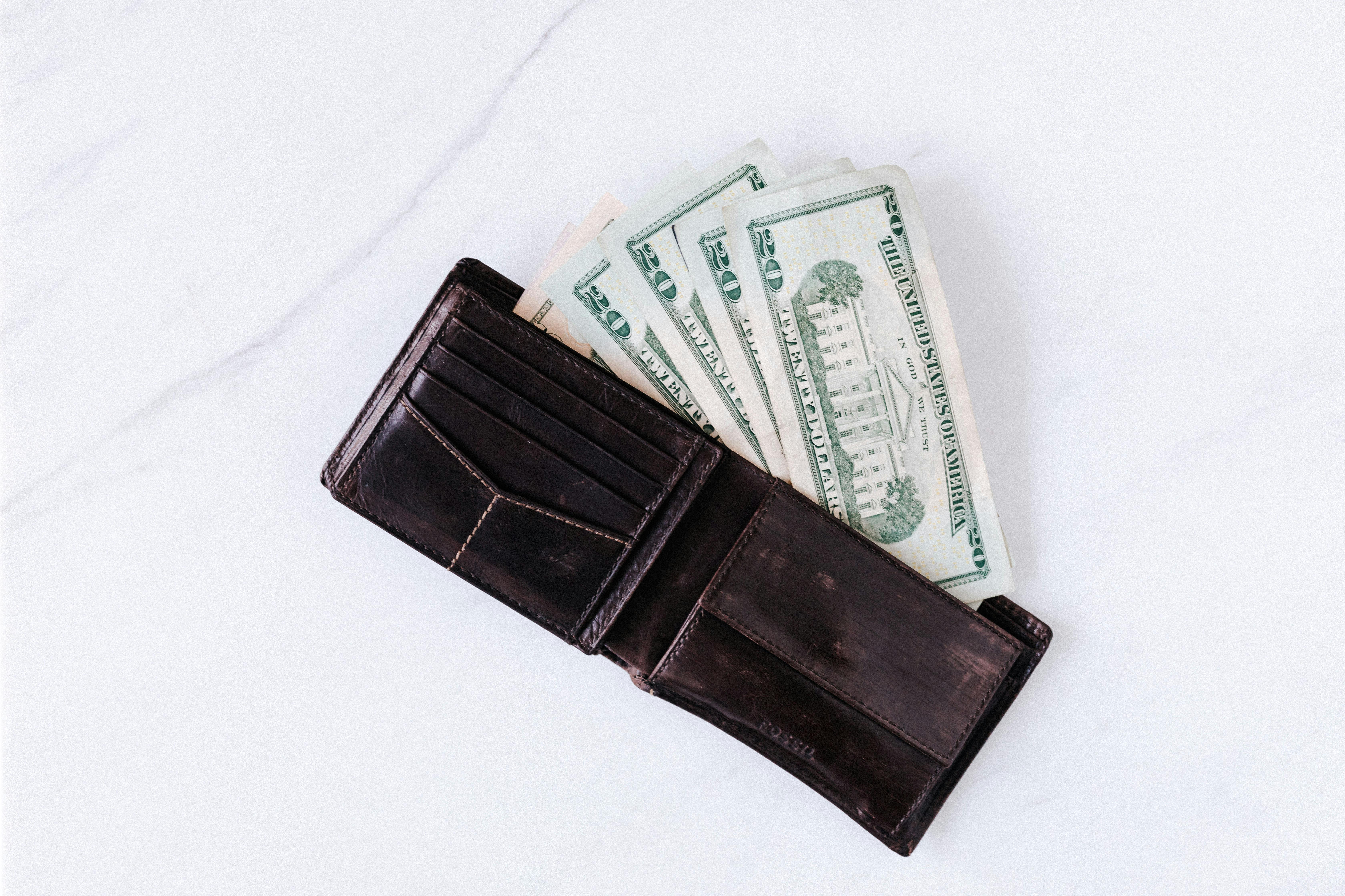 wallet with pile of american paper dollars