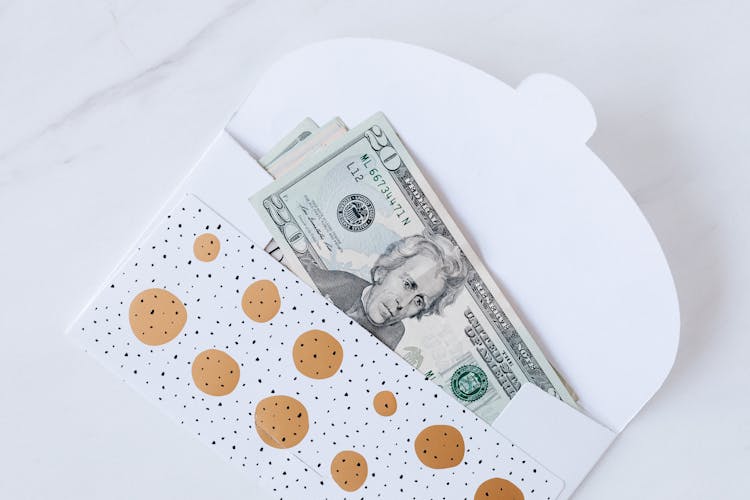 Money Envelope With American Dollar Banknotes On White Surface