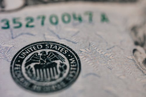 From above closeup of national symbol of USA paper money representing official seal with eagle with olive oil and arrow sitting on shield