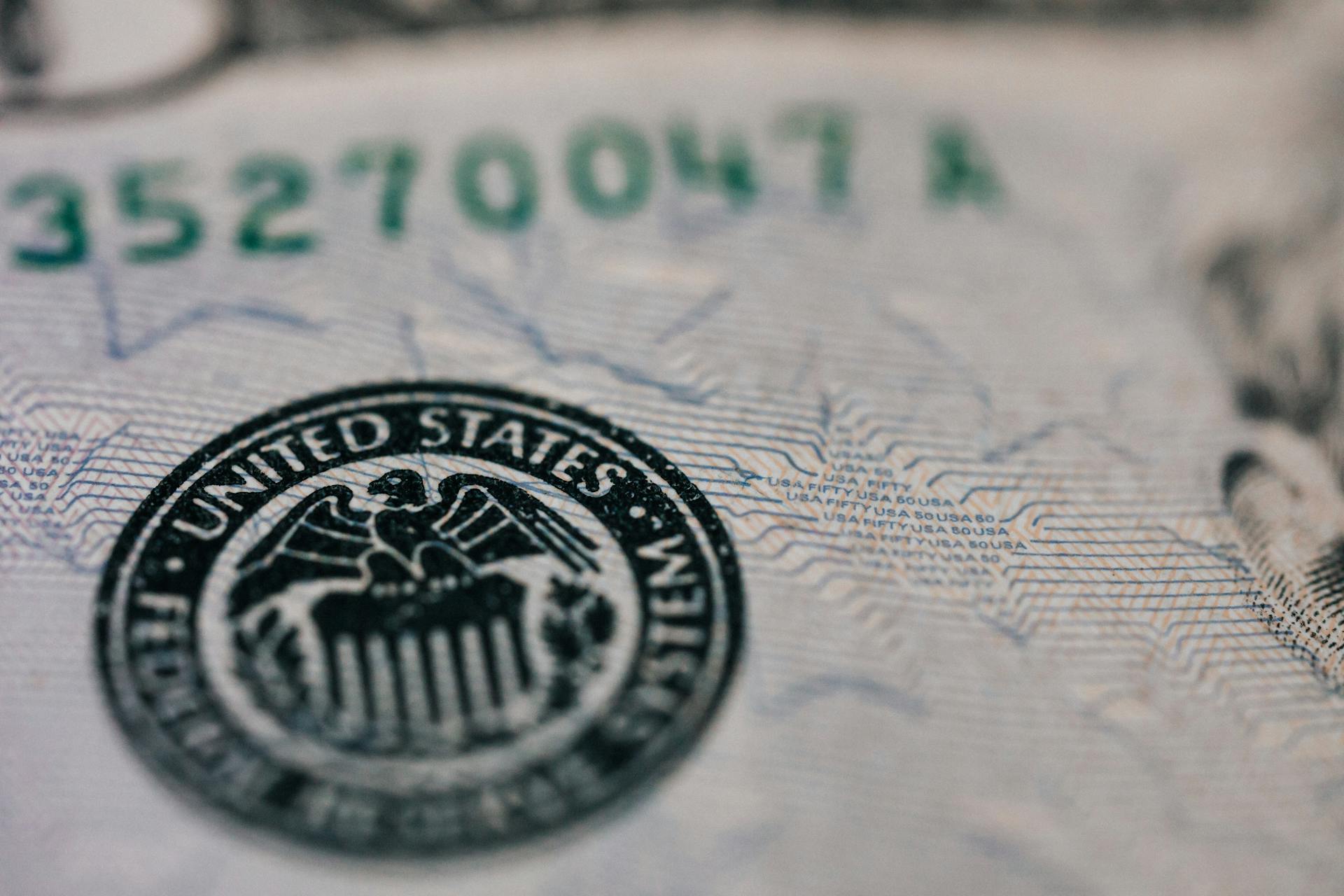 From above closeup of national symbol of USA paper money representing official seal with eagle with olive oil and arrow sitting on shield