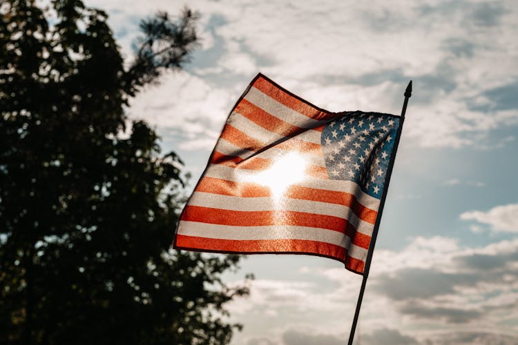 American Flag Under A Cloudy Sky