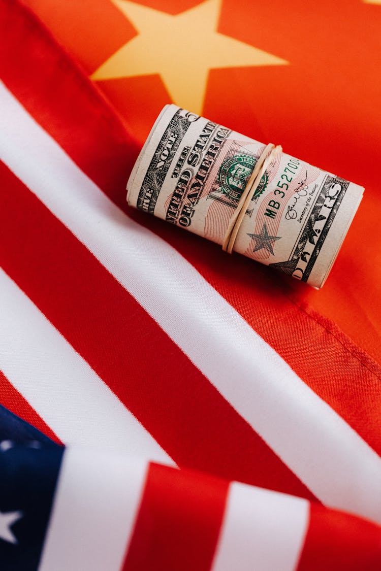 Bright American Flag With Roll Of Paper Money