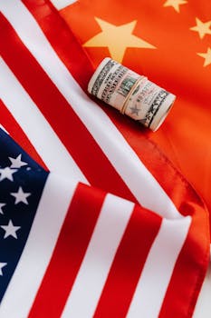 Top view of roll of dollar bills on colorful flag of United Stated of America symbolizing pride and unity