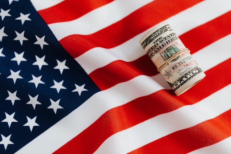 American Flag With Rolled Dollar Bills