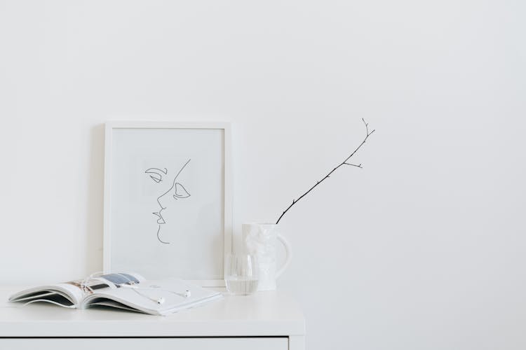 Painting, Book And Branch In Cup On Deck