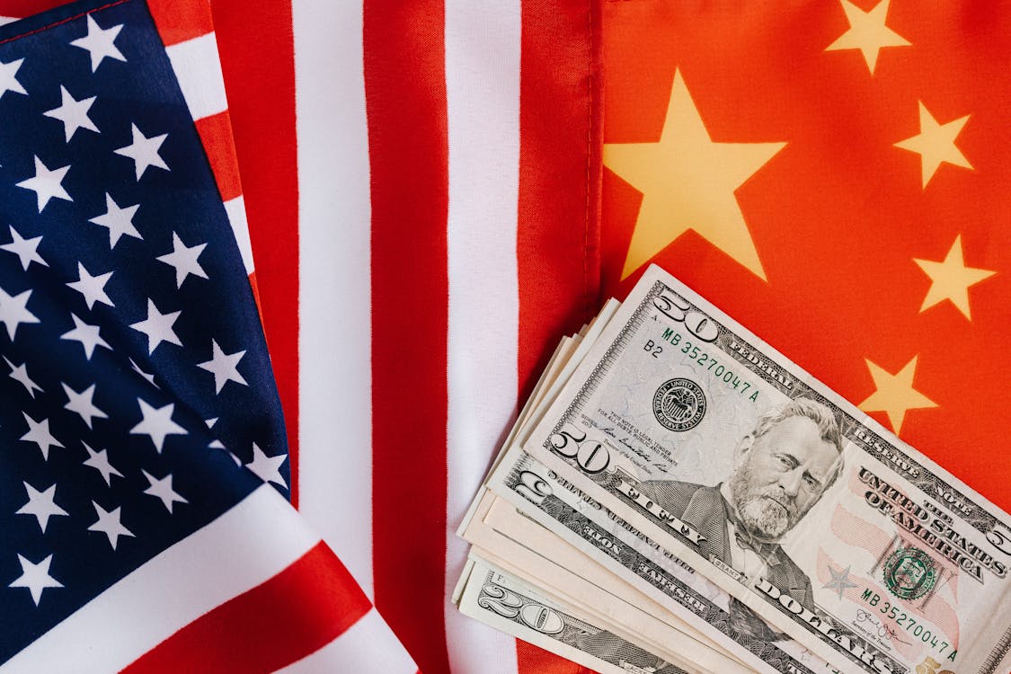 Free American and Chinese flags and USA dollars Stock Photo