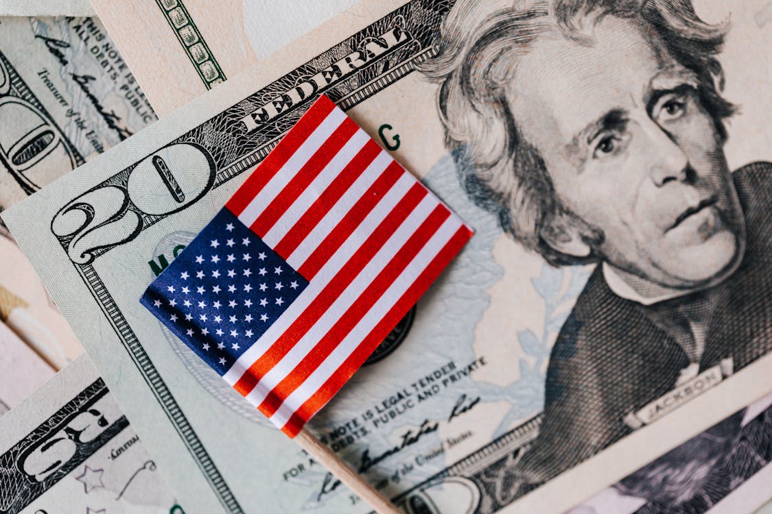 Free From above of small American flag placed on stack of 20 dollar bills as national currency for business financial operations Stock Photo