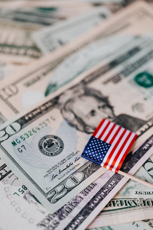 Free Stack of USA money and national flag Stock Photo