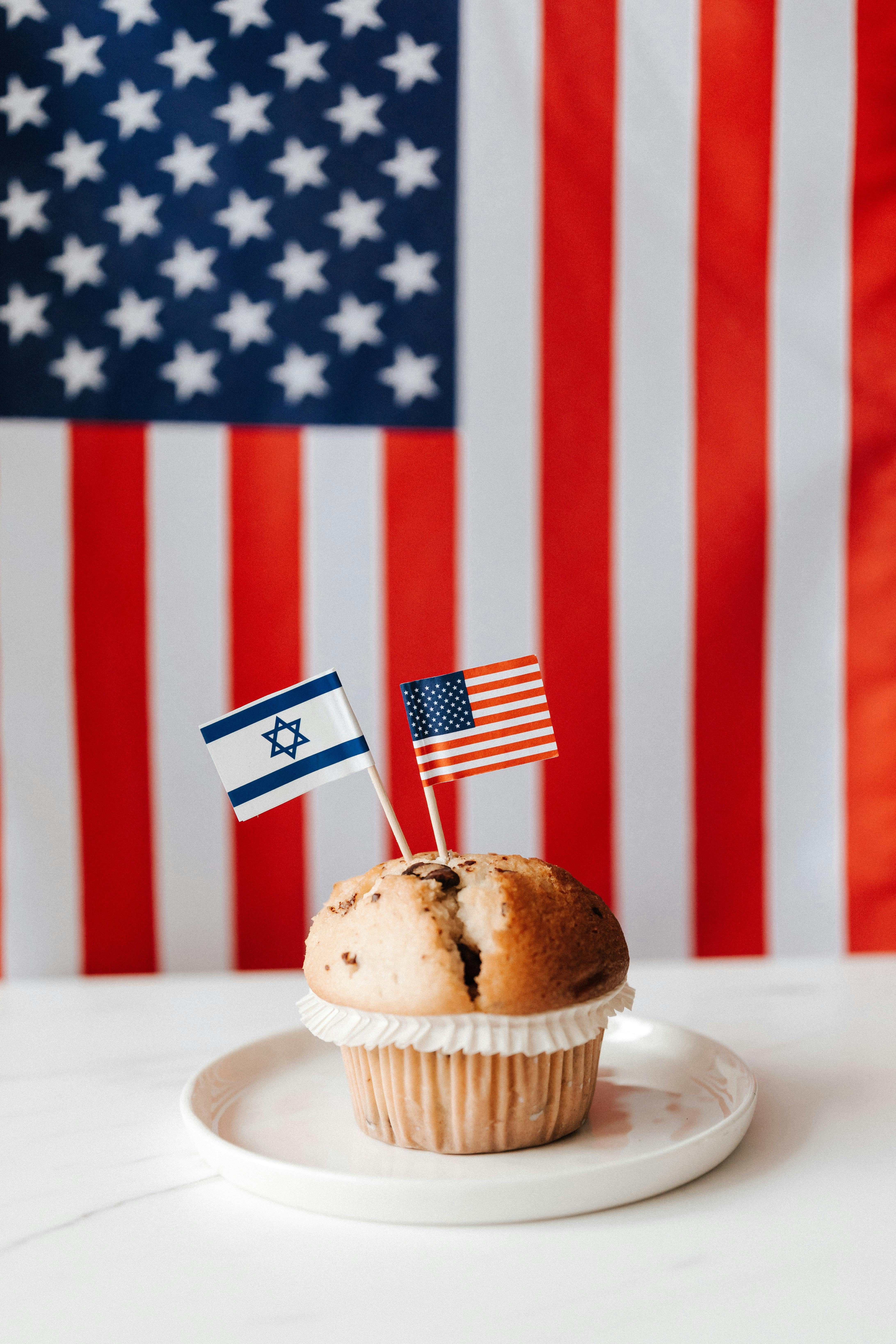 tasty muffin with national flags of usa and israel