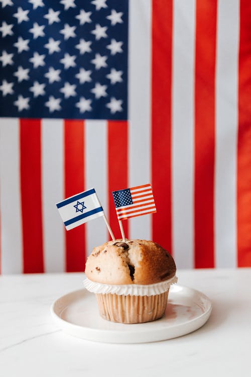 Tasty muffin with national flags of USA and Israel