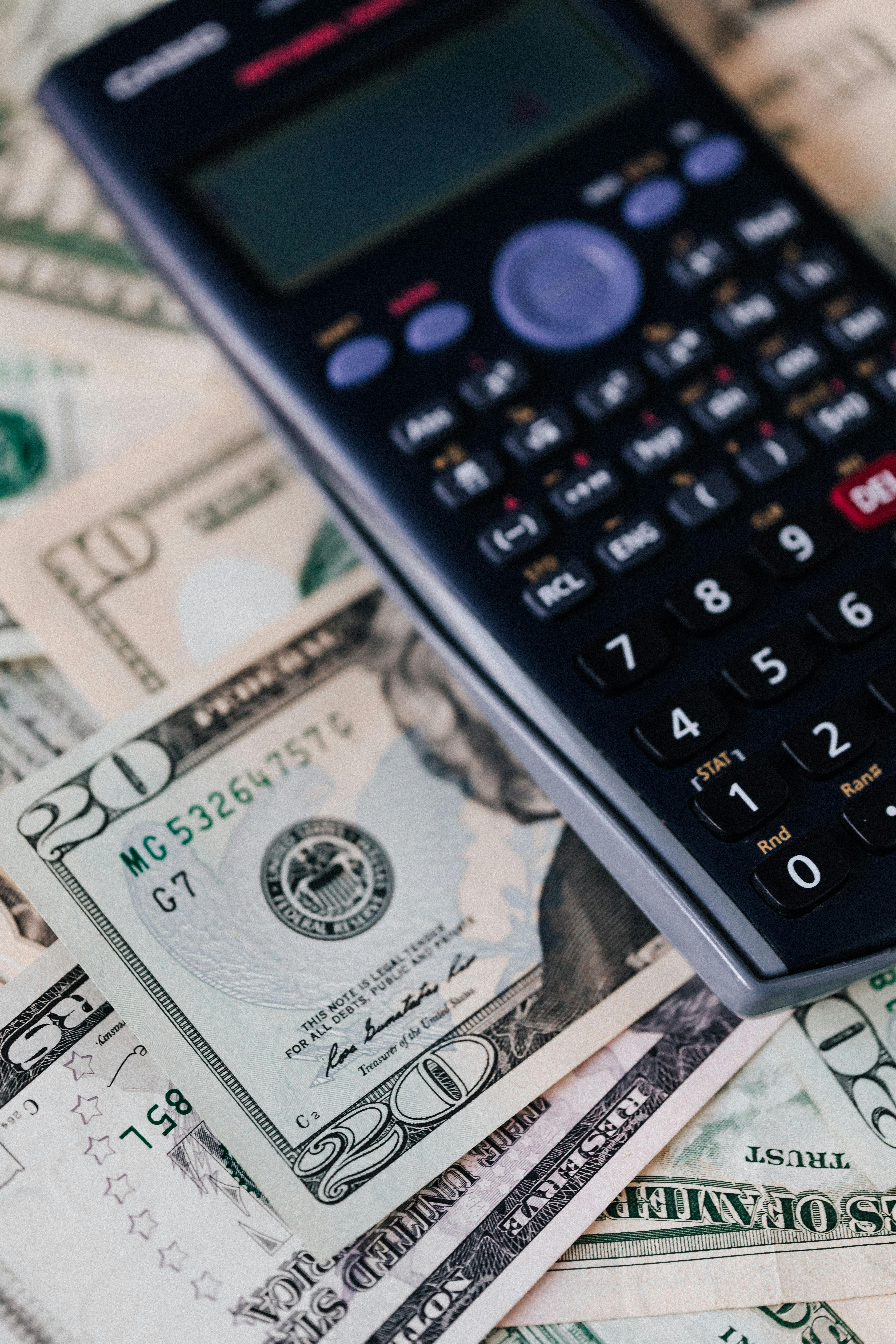 calculator on pile of paper banknotes