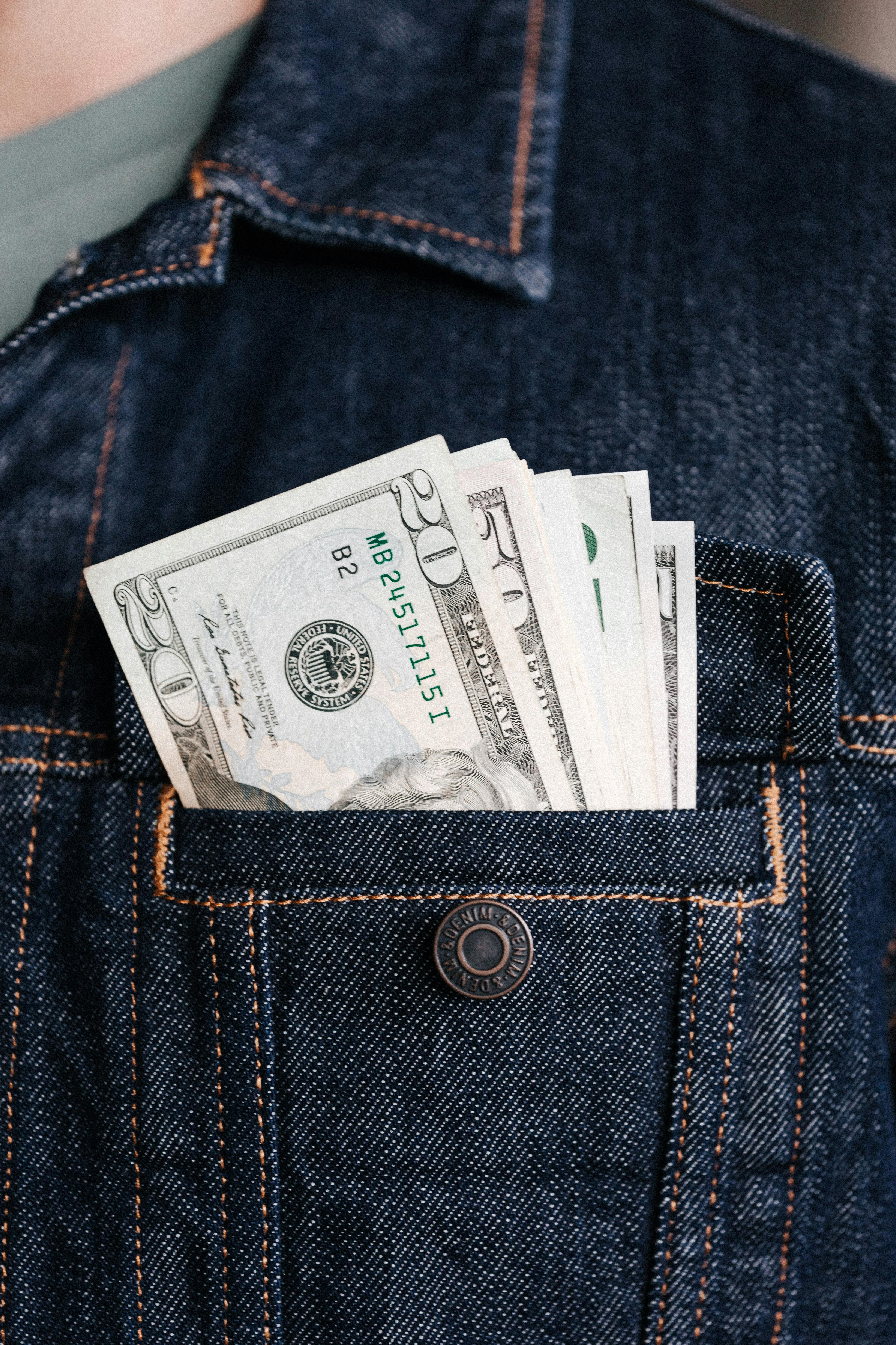 crop man with various banknotes in pocket