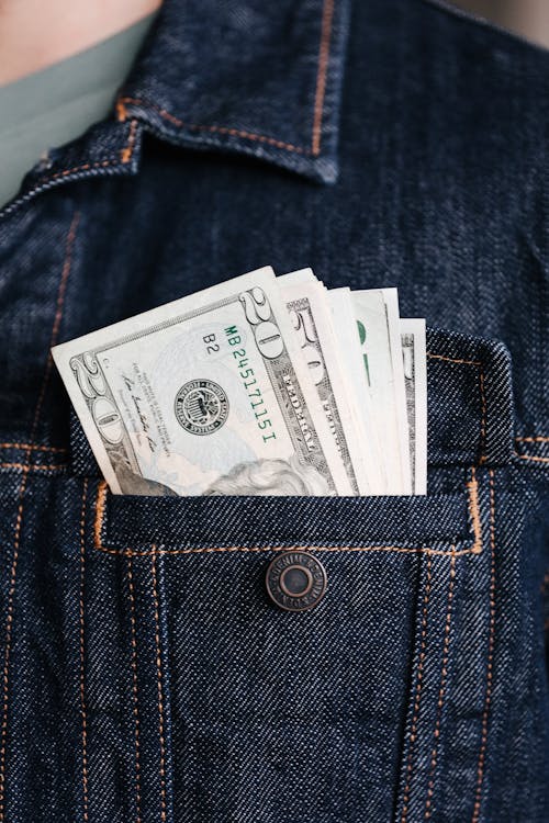 Free Crop man with various banknotes in pocket Stock Photo