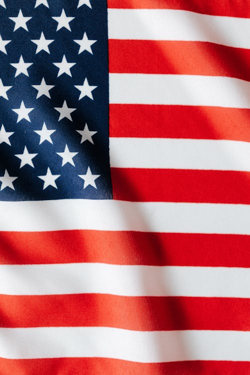 Free Middle part of waving national flag of United States of America with white and red stripes and stars on blue background Stock Photo