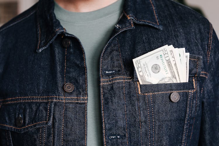 Crop Man With Dollar Banknotes In Pocket Of Jacket