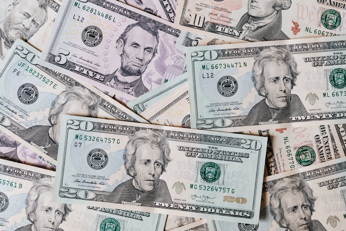 Free Top view of different types and colors American dollars placed together on each other Stock Photo
