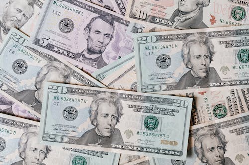 Free Top view of different types and colors American dollars placed together on each other Stock Photo